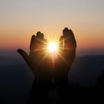 spiritual-prayer-hands-sun-shine-with-blurred-beautiful-sunset_optimized_150 (1)